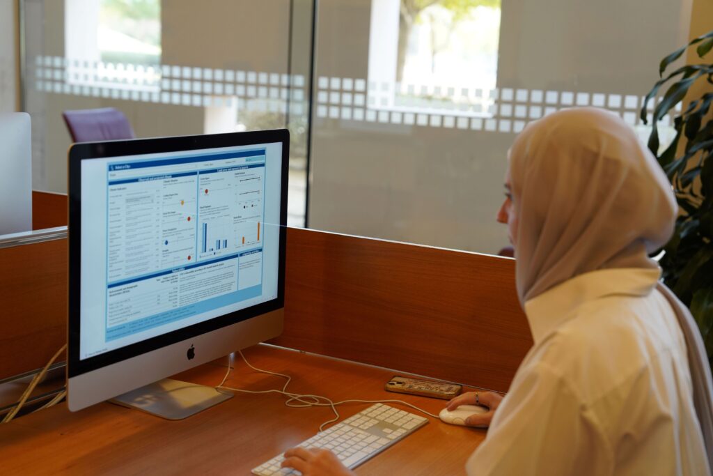 A student working on a data visualization software in the library.